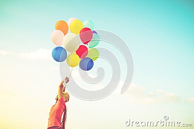 Girl hand holding multicolor balloons Stock Photo