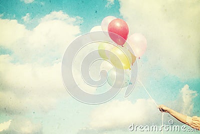 Girl hand holding multicolored balloons Stock Photo