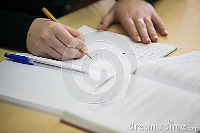 Girl hand writing down new information in exercise book Stock Photo