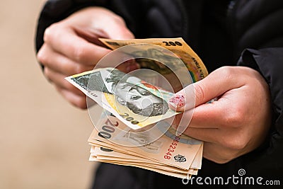 Girl hands counting money, counting Romanian LEI currency, close up Stock Photo