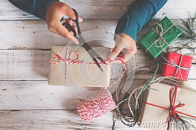 Girl hands wrapping gift for Christmas presents and New Year. Stock Photo