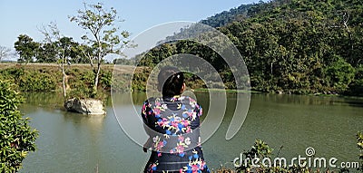 A Girl hanging out near a pond at sikuni tea estate area. Editorial Stock Photo