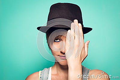 Girl in a hat and covering her eye with her hand Stock Photo