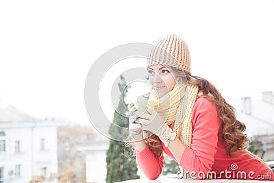 The girl in the hat froze and drinking hot tea Stock Photo