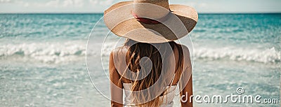 girl in a hat with her back the camera on the seashore leaves travel ocean lifestyle Stock Photo