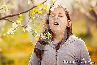 Girl having allergy outdoor. The girl sneezes. Selective focus Stock Photo