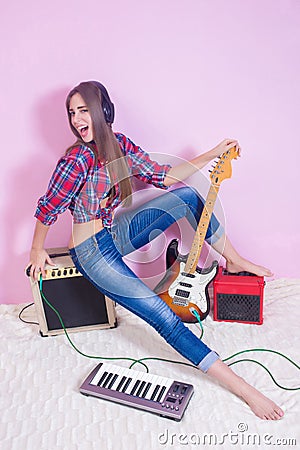 Girl in headphones listens to music. electric. Stock Photo