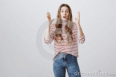 Girl heard unbelievable news. Studio shot of caucasian female student gasping, shaking hands near face and dropping jaw Stock Photo