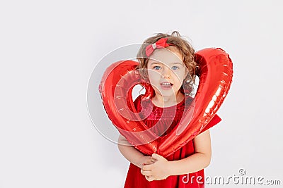 Girl with heart, beautiful little girl holding big balloon heart Stock Photo