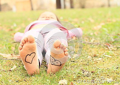 Girl with hearts on soles Stock Photo