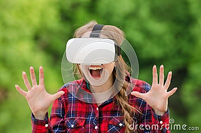 Girl in a helmet of virtual reality on a background of nature. D Stock Photo