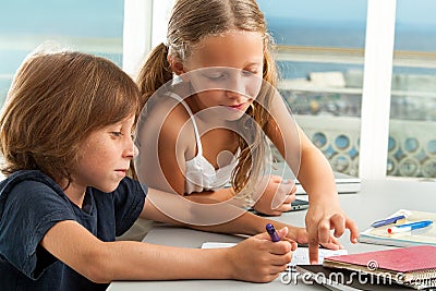 Girl helping boy with homework. Stock Photo