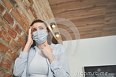 Girl with her hand on the temple Stock Photo