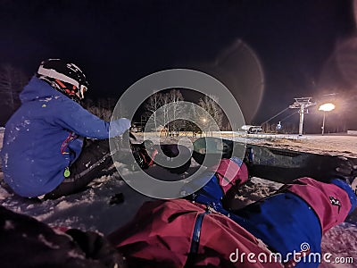 A girl with her snowboard and her first practice for snowboarding at Niseko illage, Sapporo , Japan Editorial Stock Photo