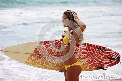 Girl with her surfboard at the beach Stock Photo