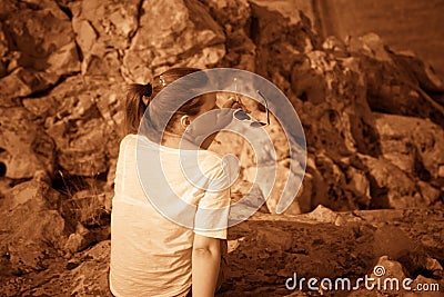 Girl on a hill in the desert. Ordinary people. Effect - Sepia. Stock Photo