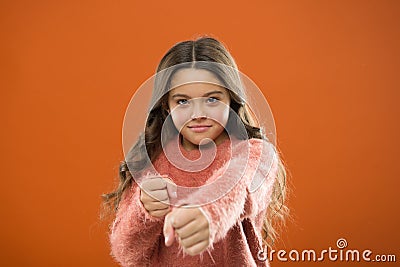 Girl hold fists ready attack or defend. Girl child cute but strong. Self defense for kids. Defend Innocence. How teach Stock Photo