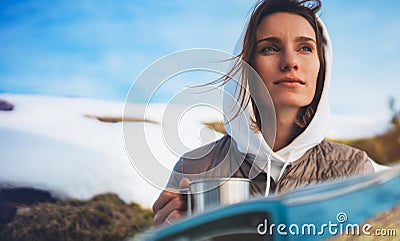 Girl hold in hands cup of drinks, relax tourist look on map, people planning trip in snow mountain, hipster enjoy on background Stock Photo