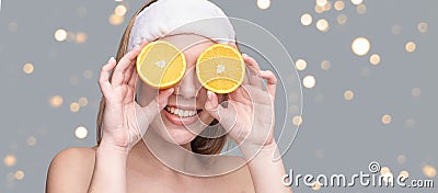 Girl hold orange slice. Citrus fruit hidding face Stock Photo