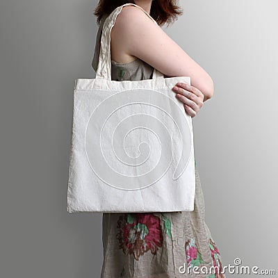 Girl is holding blank cotton eco tote bag, design mockup. Stock Photo