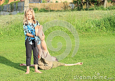 Girl holding feet of a boy Stock Photo