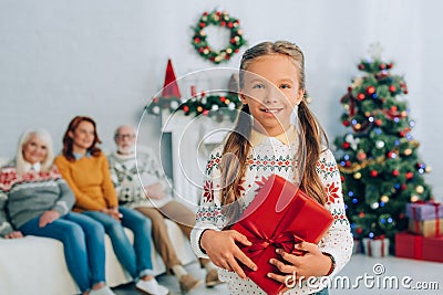 Girl holding gift box and looking Stock Photo