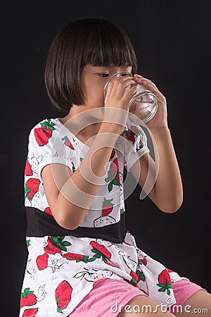 Girl is holding a glass of water Stock Photo