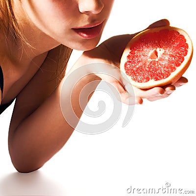 Girl holding grapefruit half Stock Photo