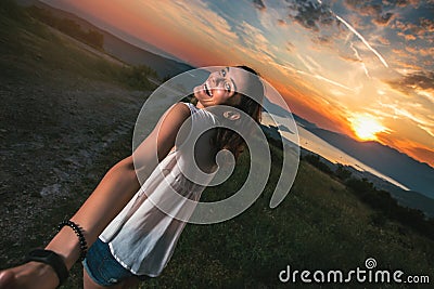 Girl holding a guy`s hand having good times in nature Stock Photo