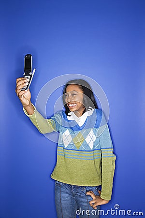 Girl holding out cellphone Stock Photo