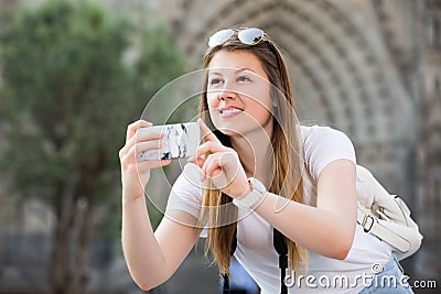 Girl holding phone and photographing Stock Photo