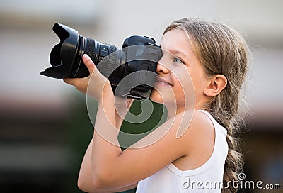 Girl holding photo camera Stock Photo