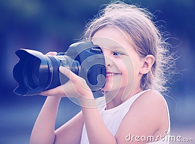 Girl holding photo camera Stock Photo