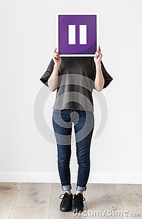 Girl holding a purple pause icon Stock Photo