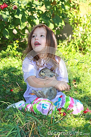 Girl holding rabbit Stock Photo