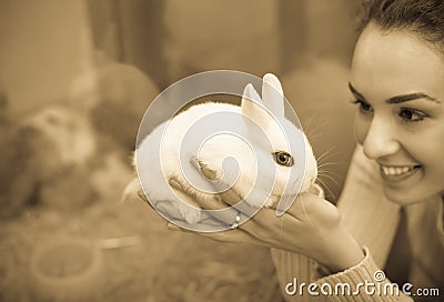 Girl holding the rabbit at pet shop Stock Photo