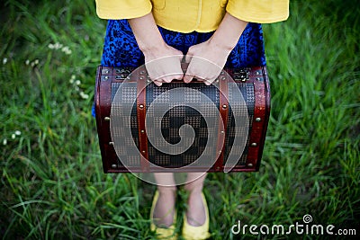 Girl holding retro vintage suitcase, travel concept, change and move concept Stock Photo