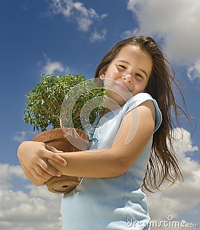 Girl holding small tree Stock Photo