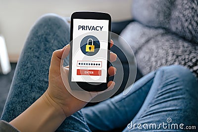 Girl holding smart phone with online privacy concept on screen Stock Photo