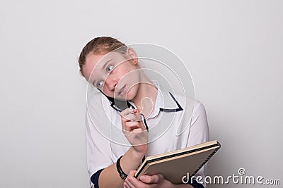 Girl holds documents and talks on the phone Stock Photo