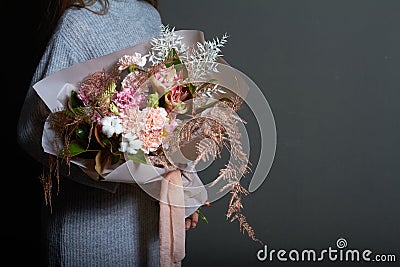 Girl holds in her hands original bouquet in vintage style, greeting background or concept Stock Photo