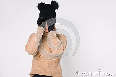 The girl holds her hands to eyes in the form of binoculars. White background Stock Photo
