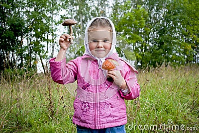 The girl holds mushrooms in hands Stock Photo