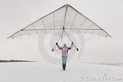 Girl holds an old hang glider wing Stock Photo