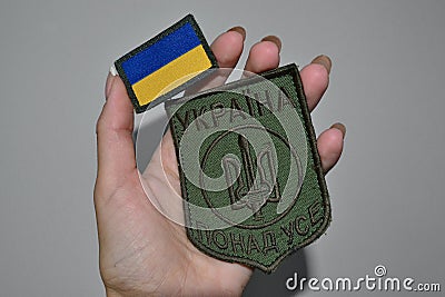 The girl holds Ukrainian chevrons in her hands Stock Photo