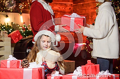 Girl at home on christmas eve. Adopting child. Kid celebrate new year with pile of gifts. Christmas traditions. Charity Stock Photo