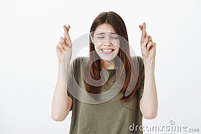 Girl hoping guy have not seen her embarrassing pictures. Portrait of nervous good-looking young woman in casual t-shirt Stock Photo