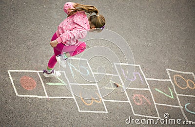 Girl on the hopscotch Stock Photo