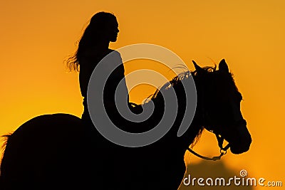 Girl and horse silhouette Stock Photo