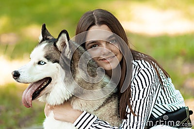 The girl hugs her furry friend. The teenager poses for a photo. The dog and it`s owner Stock Photo